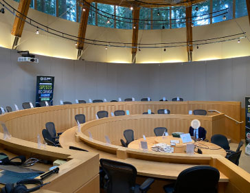 Conference hall setup with participant name tags on chairs at SIP2025.